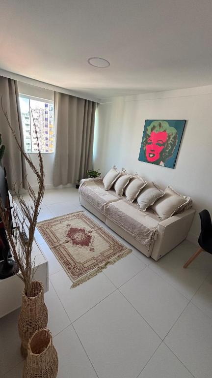 a living room with a couch and a rug at Luxury 3 minutes from the Porto da Barra beach - Fast Wi-Fi, new apartment in Salvador