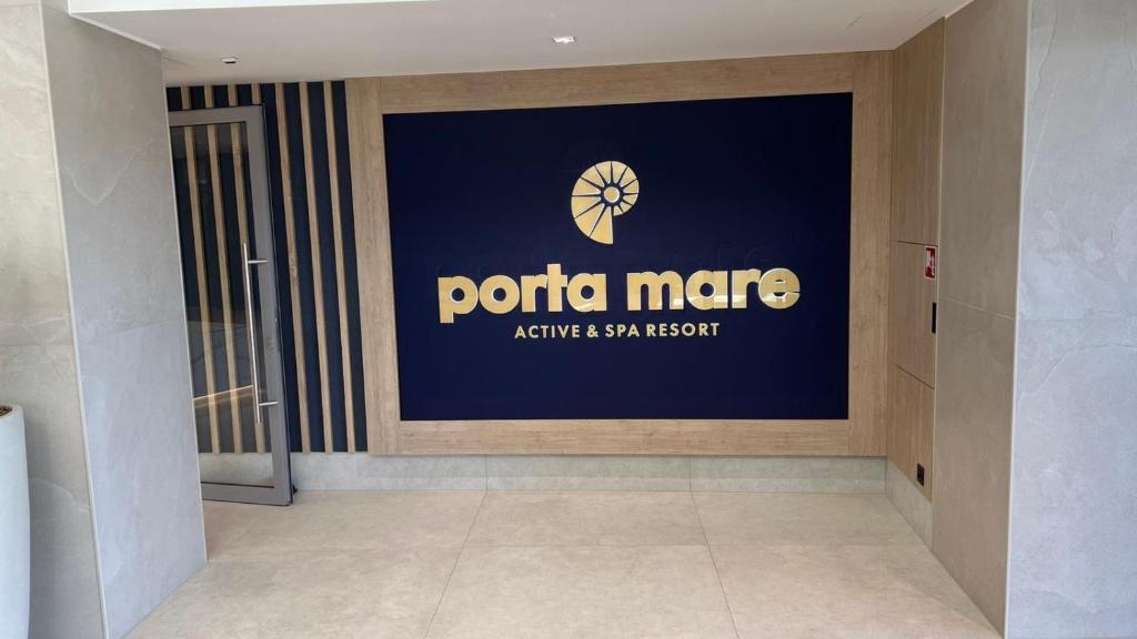 a sign on the side of a corporate building at Porta Mare - Dziwnówek - Ferienappartment an der polnischen Ostsee in Dziwnówek