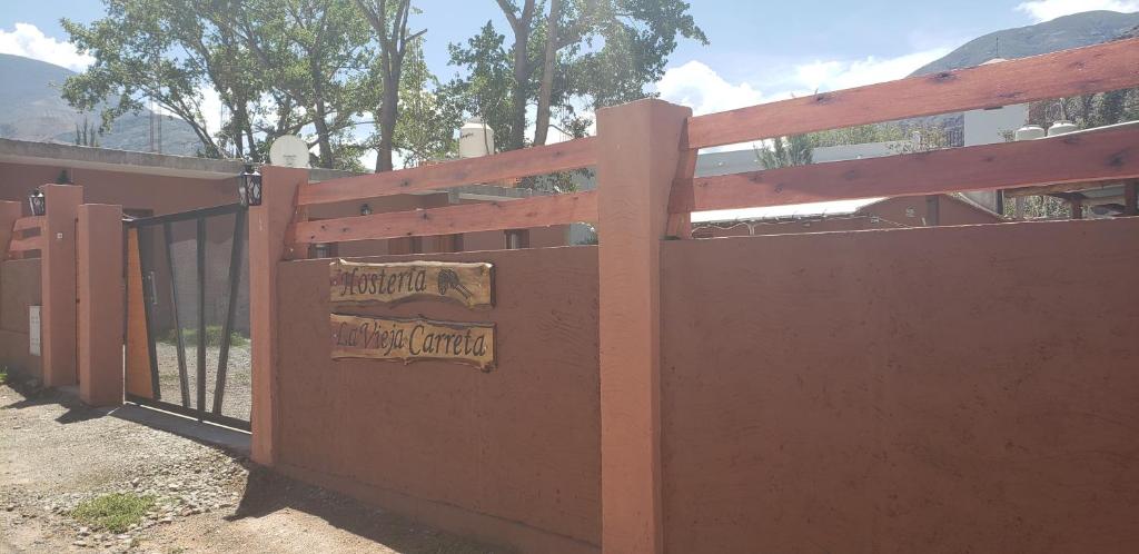 a wooden fence with a gate in front of a building at Hosteria LA VIEJA CARRETA in Purmamarca