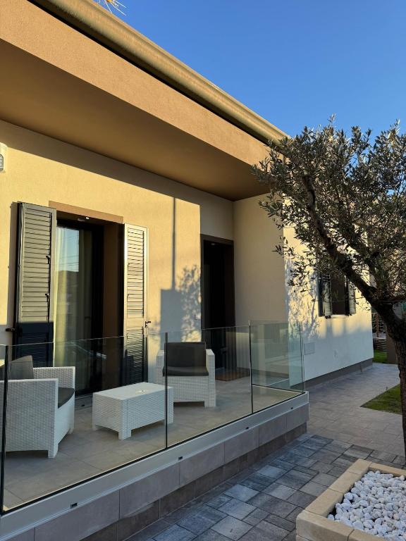 a balcony of a house with chairs and a table at Dimora degli Ulivi in Rimini