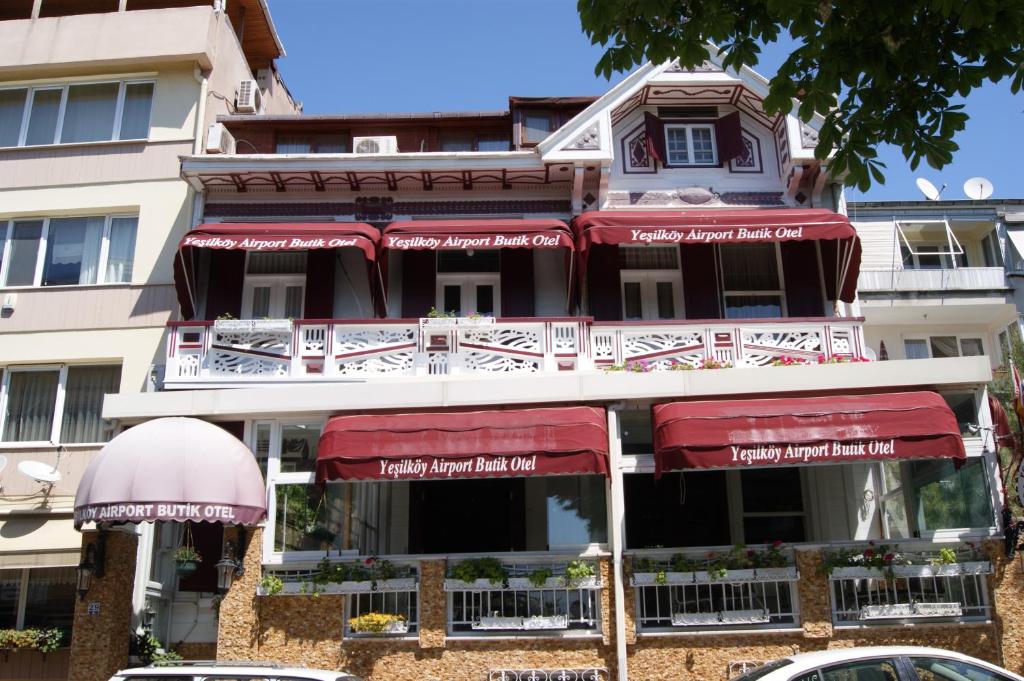 a building with red umbrellas in front of it at Yeşilköy Airport Hotel in Istanbul