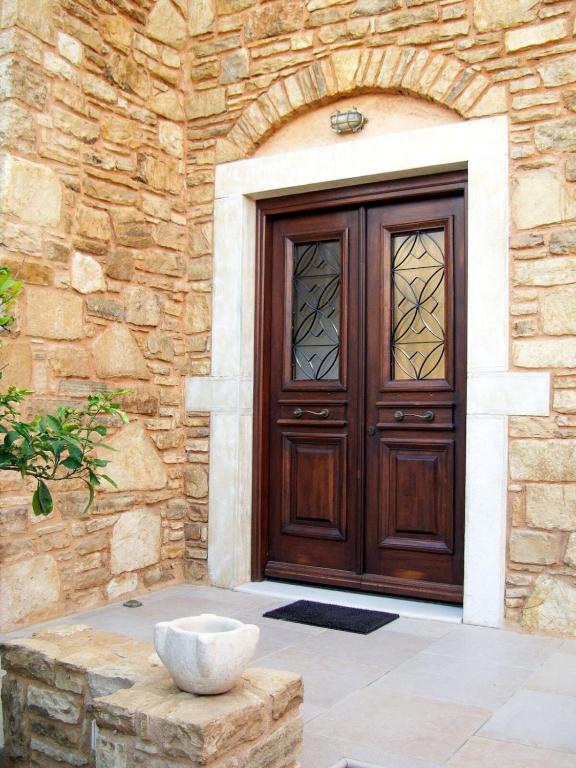 a door of a stone building with a bowl in front at One&Only Kalamoti Gem Retreat in Kalamoti