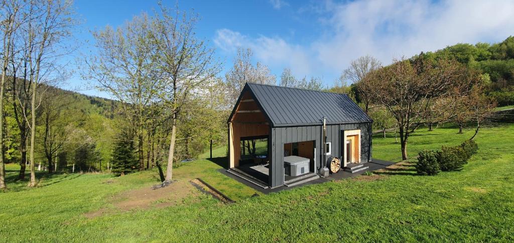 a small cabin in the middle of a field at OFF Chata na Oślaku, Jacuzzi & Sauna in Jaworzna