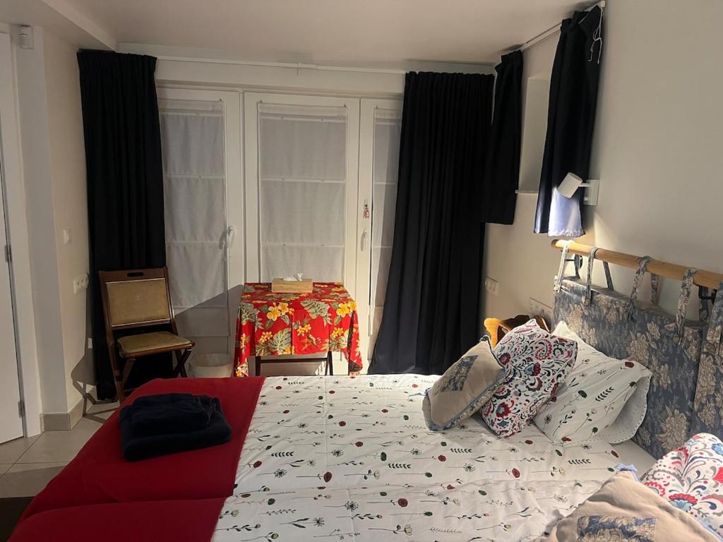 a bedroom with a bed and a table in the window at Céline Apartment in Chaumont-Gistoux
