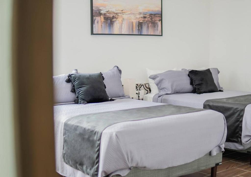 Postel nebo postele na pokoji v ubytování Hotel Atilana