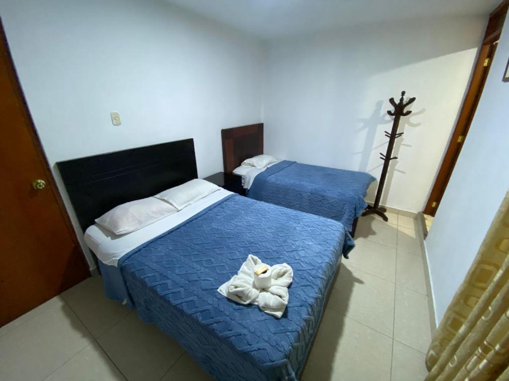 Postel nebo postele na pokoji v ubytování Hostal Milagros