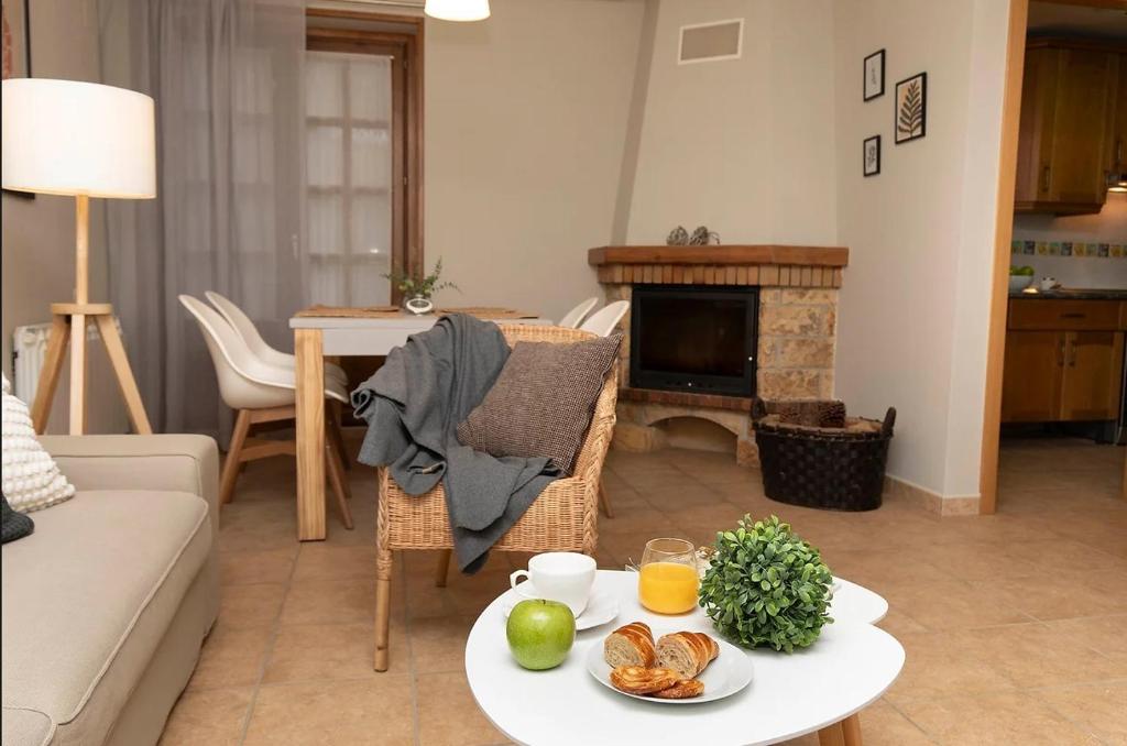 a living room with a table with food on it at El Bosque del Sapo in El Pueyo de Jaca