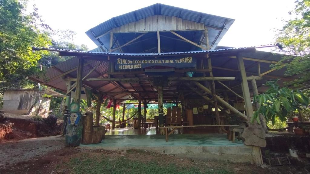 a building with a blue roof with a sign on it at Rincon Ecologico Cultural Terraba in Buenos Aires