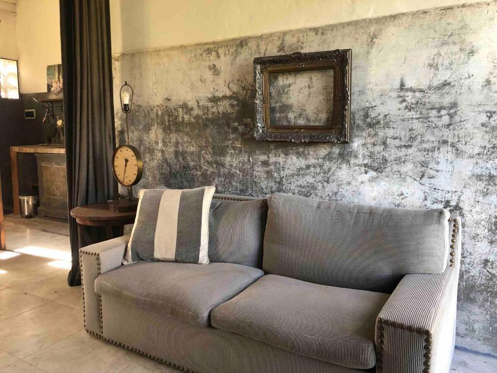 a living room with a couch and a picture on the wall at Los Rosales - Genuinamente Campo in Torres