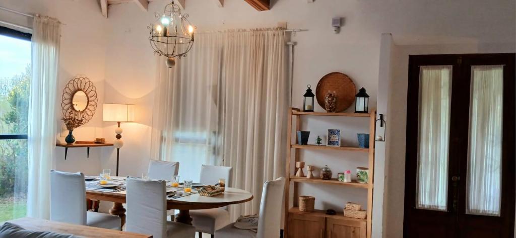 a dining room with a table and chairs and a window at La Mora Home - Casa de Campo in Victoria