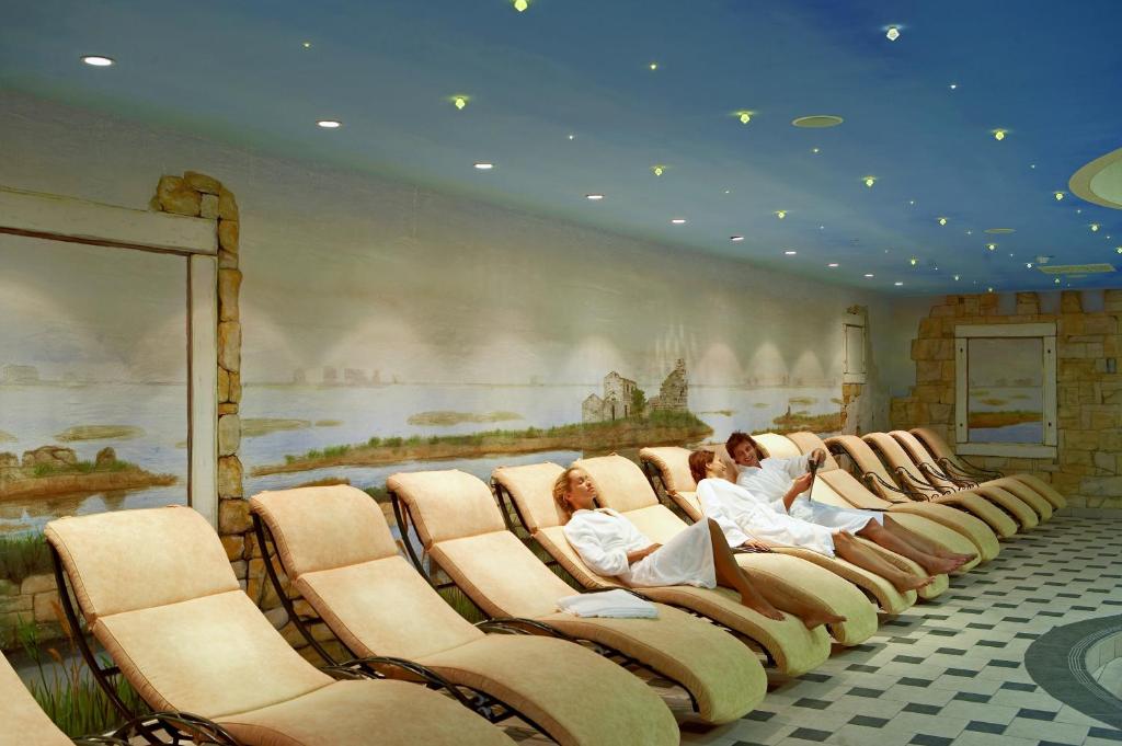 a row of chairs in a room with a painting at Hotel Neptun - Terme & Wellness Lifeclass in Portorož