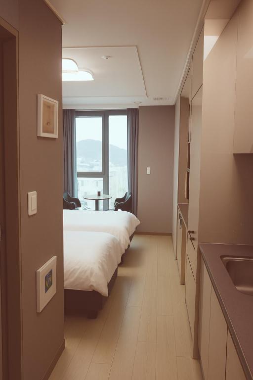 Postel nebo postele na pokoji v ubytování Someone Hotel