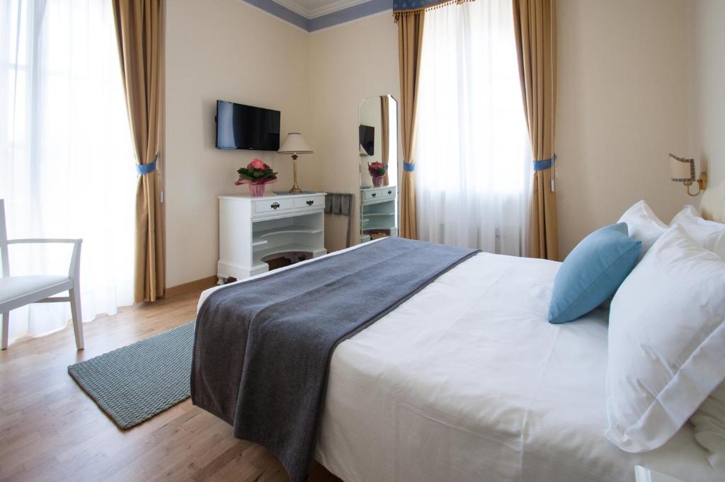 Postel nebo postele na pokoji v ubytování Hotel Villa Erica