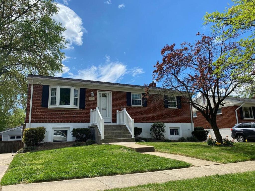 a red brick house with a white door at North Bethesda Gem - Entire House 5 min from Metro in Rockville