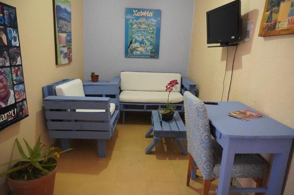 a living room with a couch and a table at A mini apartment in Cuernavaca, in a good location in Cuernavaca