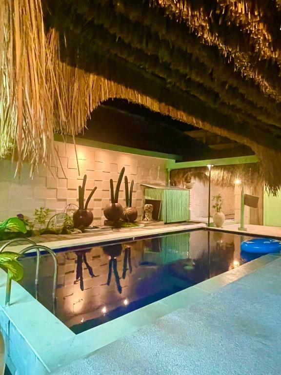 a swimming pool in a house with cactuses at LAVENDER STAR HOUSE h in Kuta