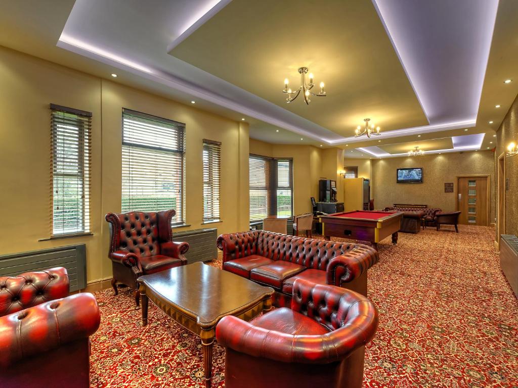 a waiting room with leather couches and a pool table at Grainger Hotel in Newcastle upon Tyne