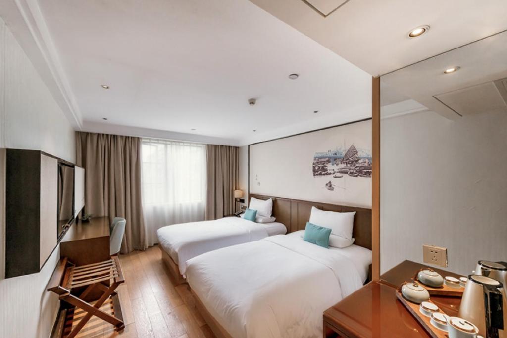 Postel nebo postele na pokoji v ubytování Guangzhou City Join Hotel Shipai Qiao metro Branch