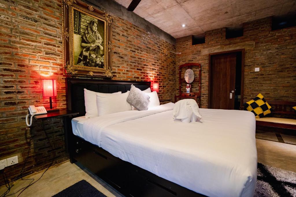 Postel nebo postele na pokoji v ubytování Aayu Hanthana Boutique Hotel