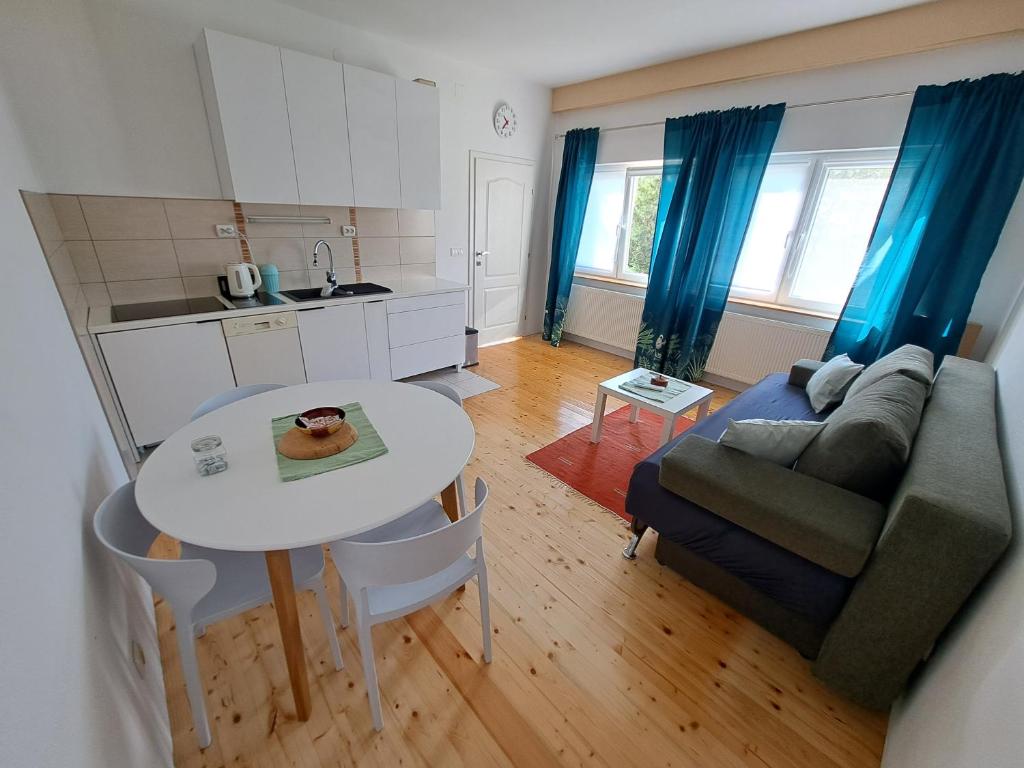 a kitchen and a living room with a table and a couch at Dona 2 in Sarajevo