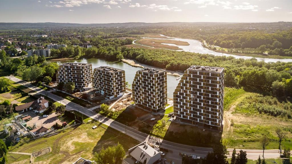 an aerial view of three buildings next to a river at GOLD APARTMENTS Panorama Kwiatkowskiego in Rzeszów
