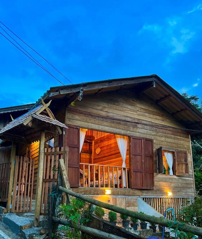 a wooden house with a fence in front of it at Poka-Homestay in Ban Pok Nai
