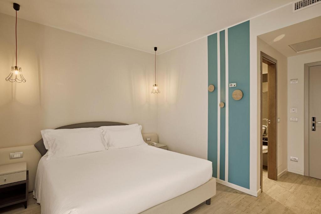 Een bed of bedden in een kamer bij Hotel Le Mura