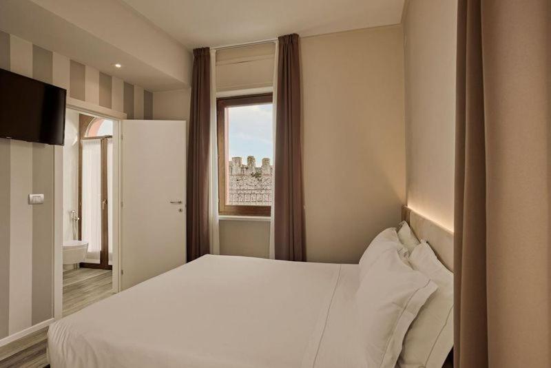 Een bed of bedden in een kamer bij Hotel Le Mura