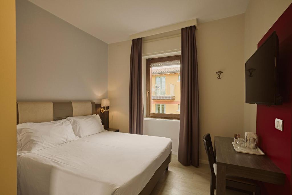 Een bed of bedden in een kamer bij Hotel Le Mura