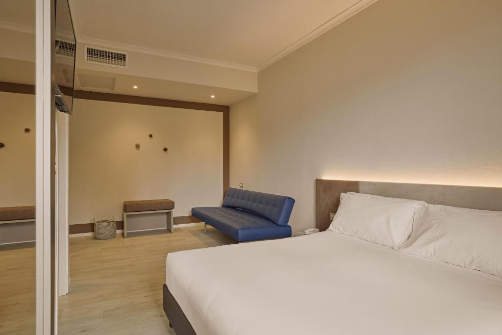 Een bed of bedden in een kamer bij Hotel Le Mura