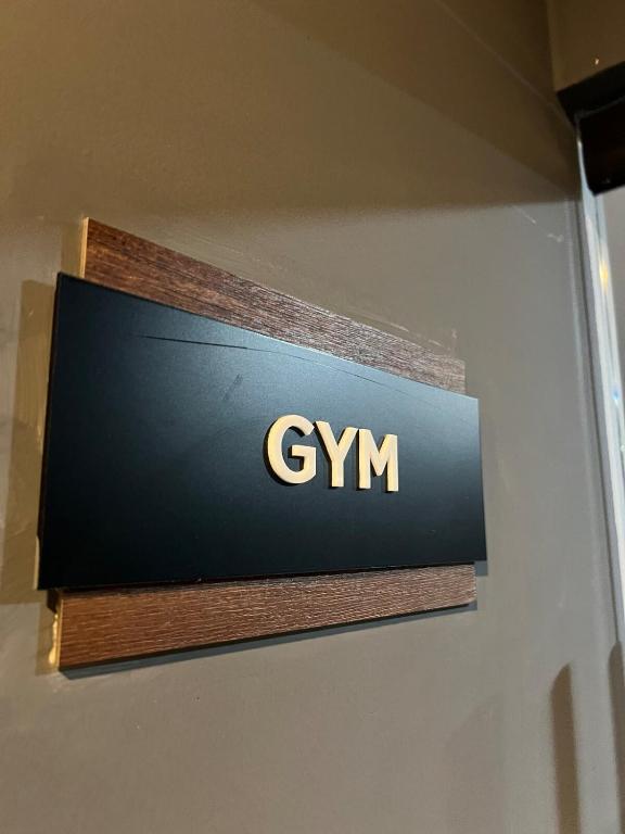 a sign for a gym on a wall at Luxury 2bdr Apt with Direct Pool in Paramar Black in Tulum