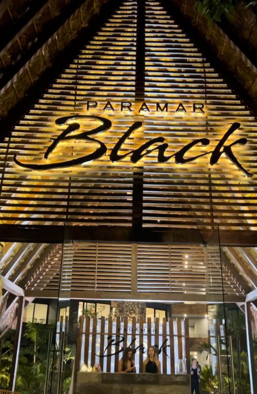 a store front with a sign on the front of it at Luxury 2bdr Apt with Direct Pool in Paramar Black in Tulum