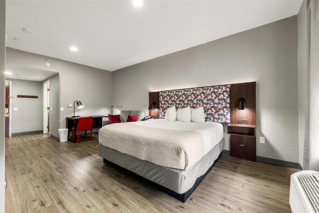 a hotel room with a large bed and a desk at Hawthorn Extended Stay by Wyndham College Station in College Station