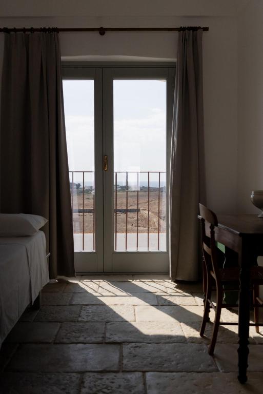 Letto o letti in una camera di Masseria Specula