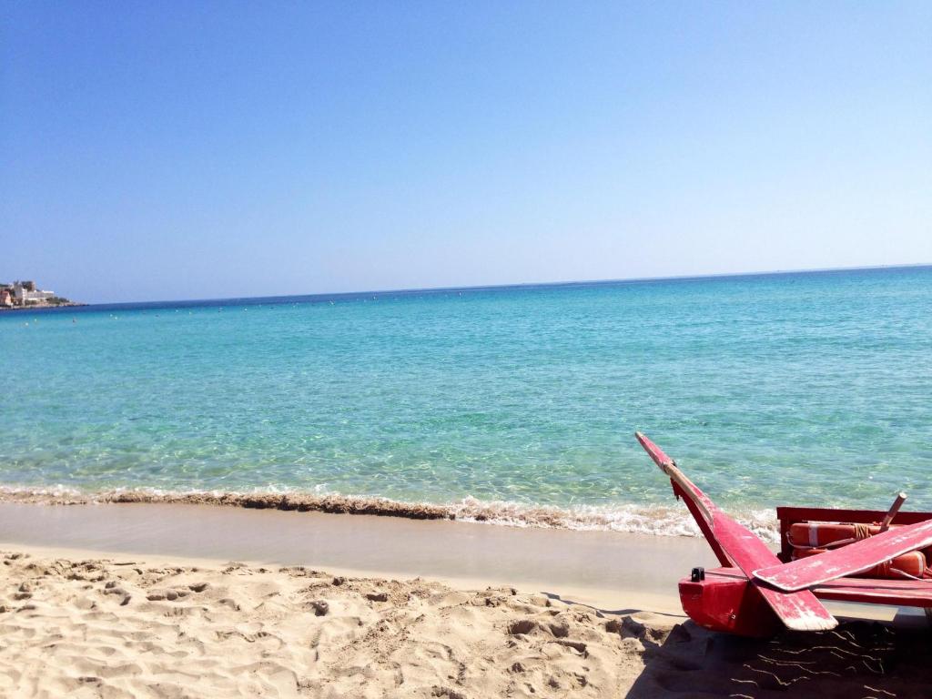 a red toy airplane sitting on the beach at Chris House Mondello in Palermo