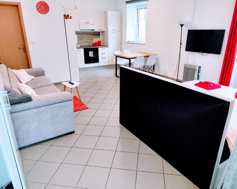 a living room with a couch and a tv at Soca treasure with free parking in Bovec