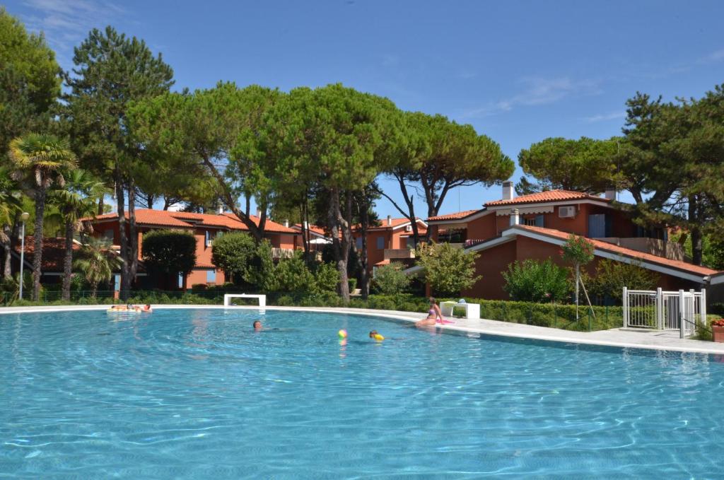a group of people swimming in a swimming pool at Villaggio Euro Residence Club in Bibione