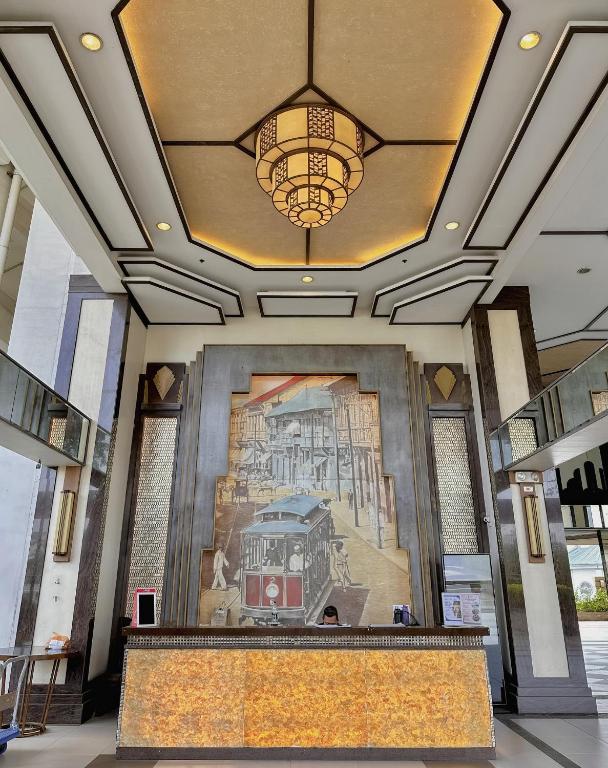 a lobby with a large painting on the wall at The Intramuros Suite in Manila