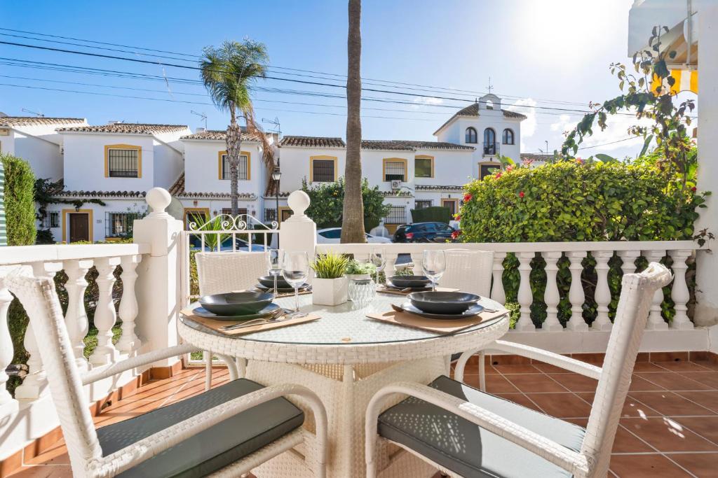 a white balcony with a table and chairs at La Campana apt with pool by Costarentals - Ref 60 in Santa Fe de los Boliches