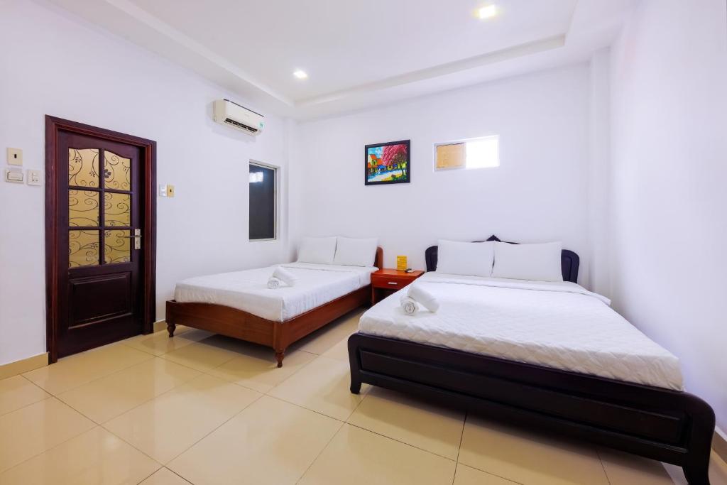 Giường trong phòng chung tại Mangolia Hotel