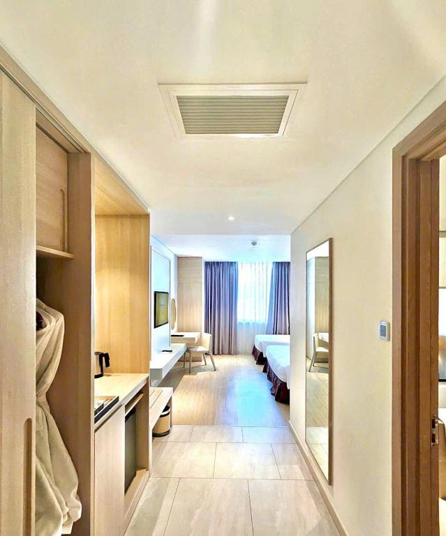 Postel nebo postele na pokoji v ubytování DQua Hotel