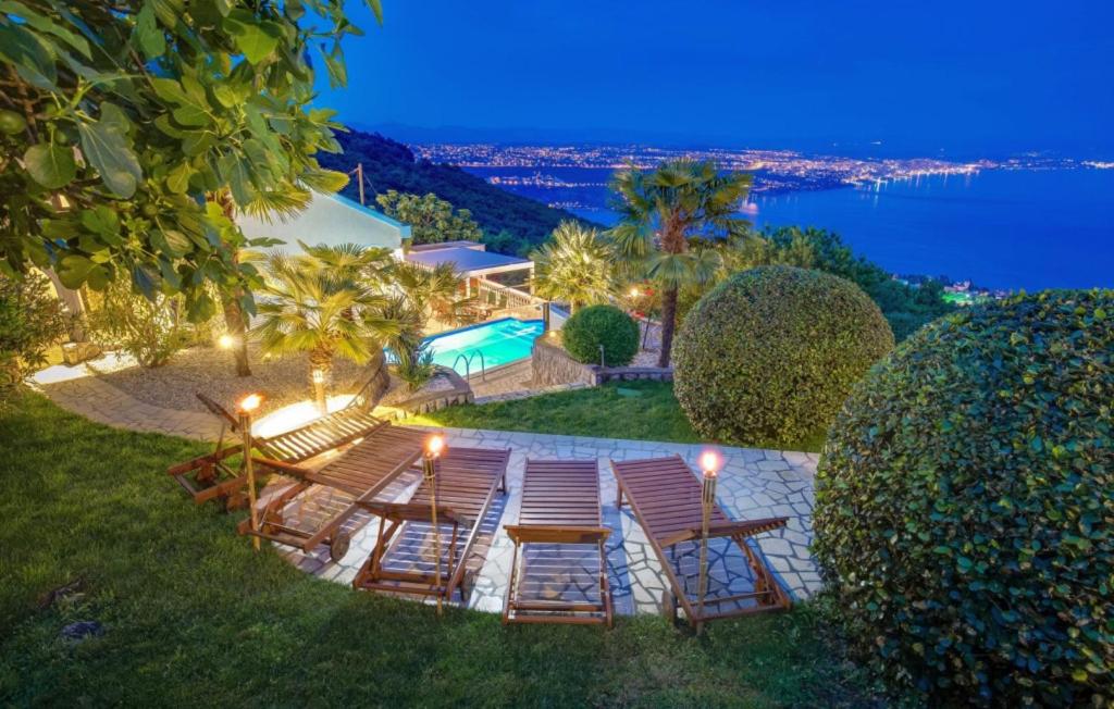 a group of chairs and tables with a view of the water at Vila Iris - Opatija by Villas Guide in Breza