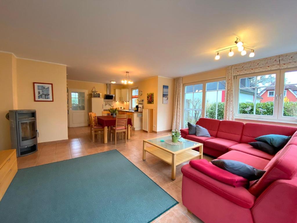 a living room with a red couch and a table at Ferienhaus Mein Panama in Zingst