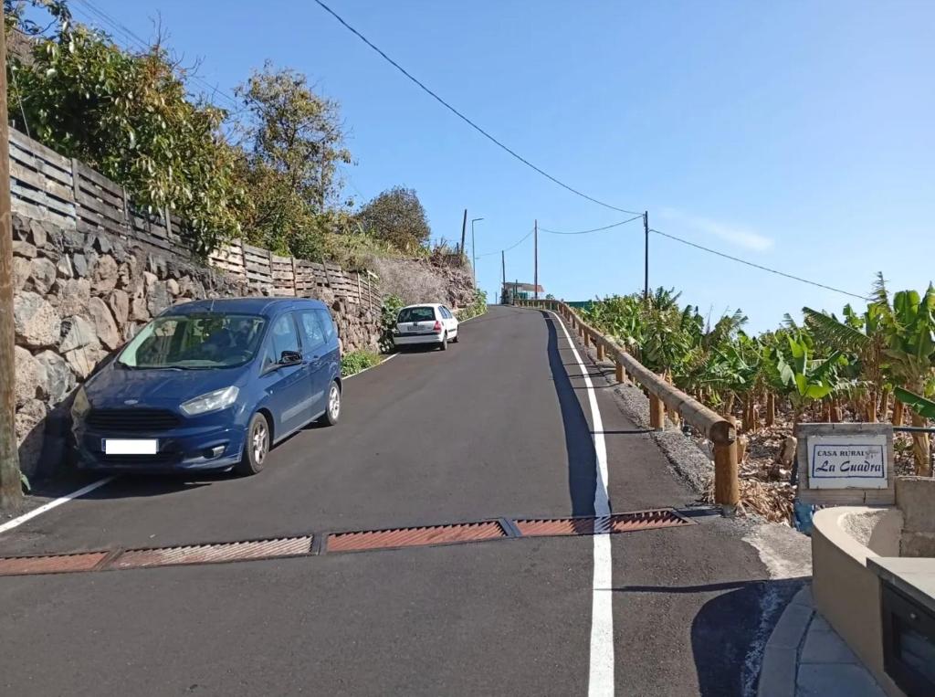 a blue van parked on the side of a road at Casa Rural La Cuadra in Hermigua