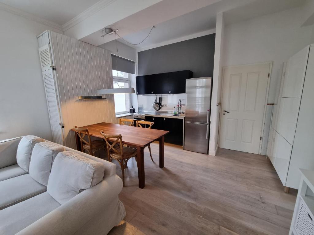 a kitchen and dining room with a table and a couch at Ferienwohnung mit Meerblick & 2 Balkonen in Sassnitz