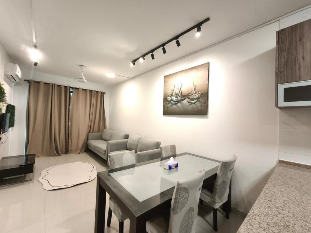 a living room with a table and a couch at Forest City 2Bedroom 5 Pax Duty Free in Gelang Patah