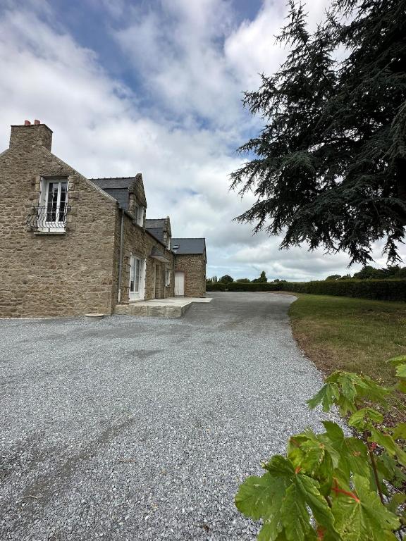 une route vide devant un bâtiment en briques dans l'établissement Chez Angèle - calme - proche plages - wifi, à Saint-Coulomb
