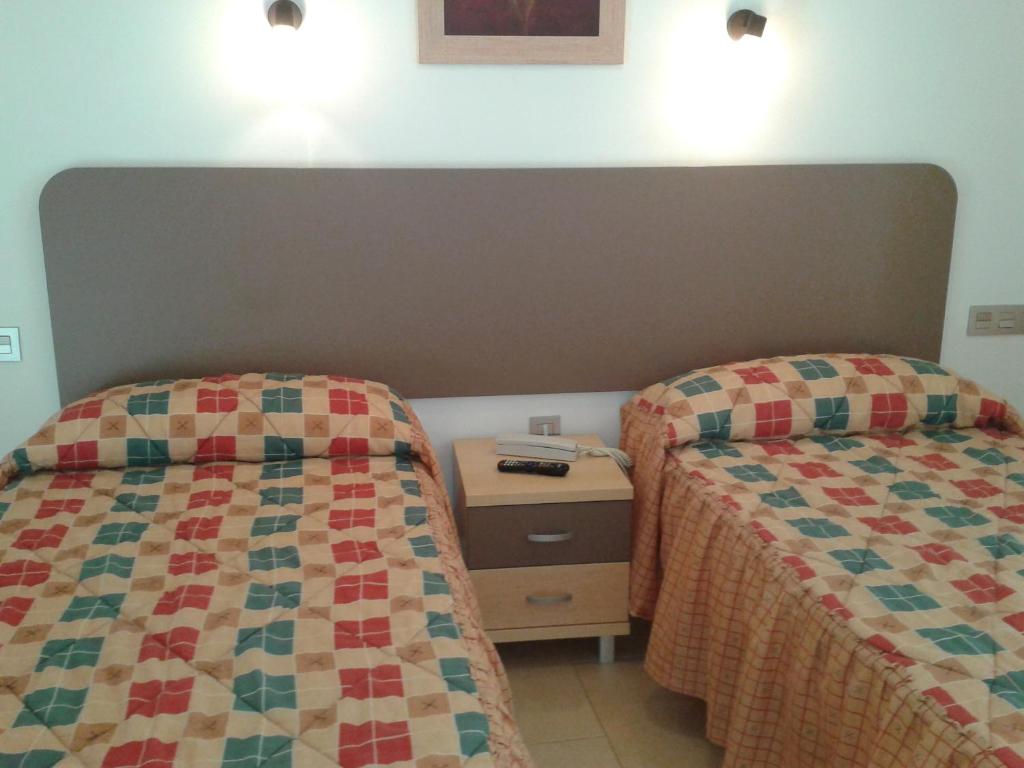 Postel nebo postele na pokoji v ubytování Hostal San Marcos