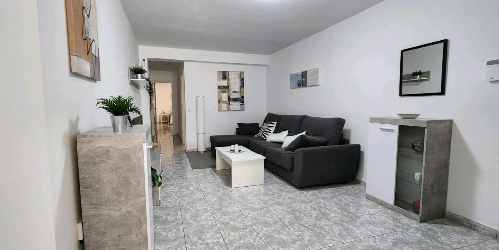 a living room with a couch and a table at Fantastic Holiday Apartment in Arona