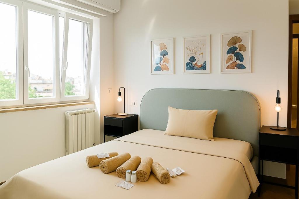 a bedroom with a bed with two towels on it at Don Gaetano Apartment - Nel Cuore di Napoli in Naples